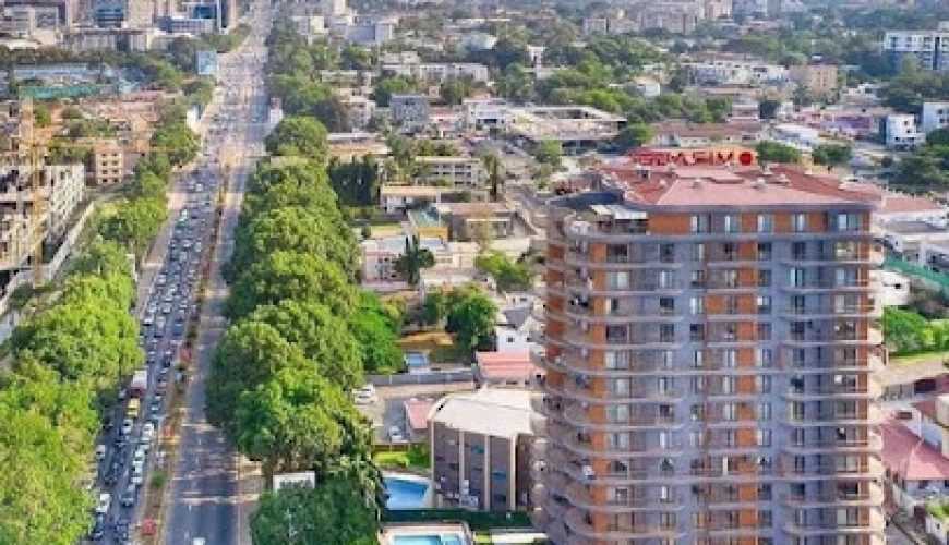 Aerial view of cityscape with high-rise buildings and road.